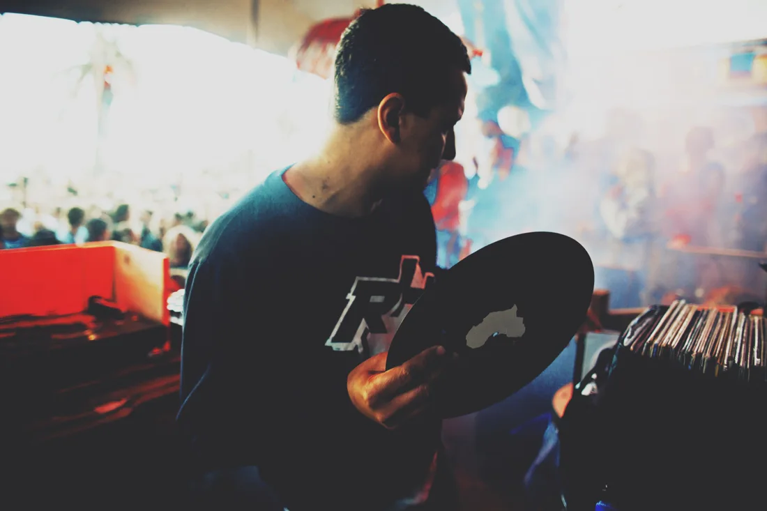 Antal selecting a vinyl record while DJing