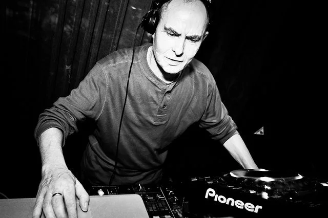 Eddie Richards wearing headphones at the decks