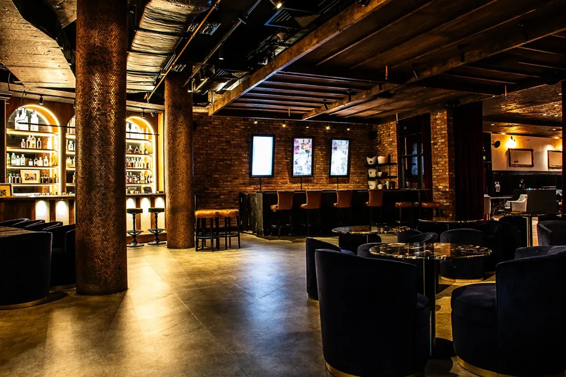 45 London Parallel 45 basement bar with brick walls and velvet armchairs