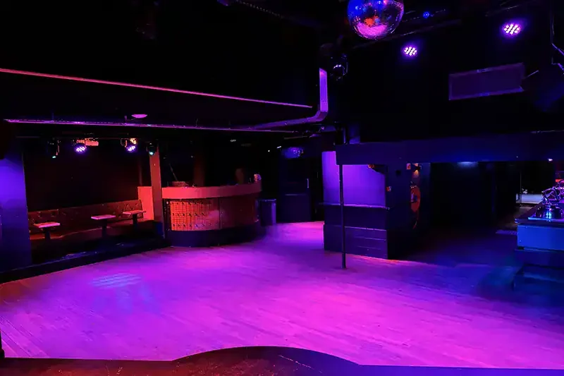 Akhnaton empty club floor with mirror ball, booths and curved bar