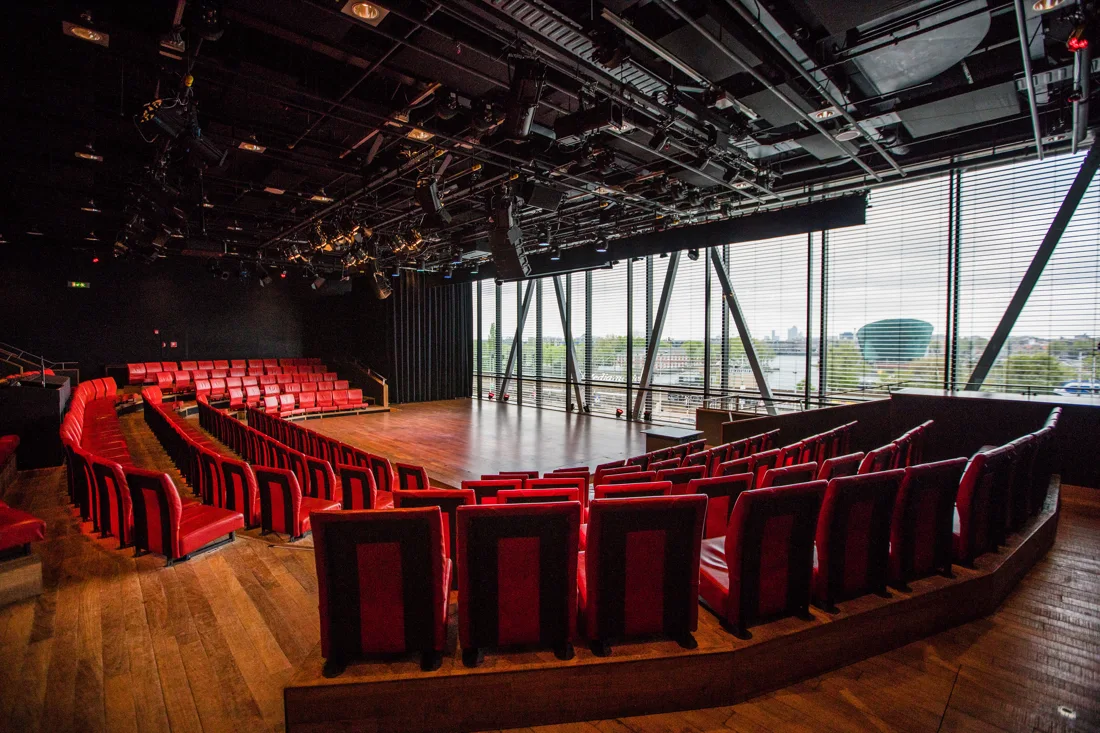 Bimhuis concert hall: red seat tiers, stage, glass wall onto the IJ