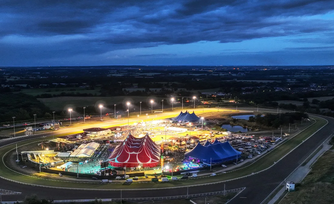 Chelmsford City Racecourse aerial at dusk, festival big tops on the infield