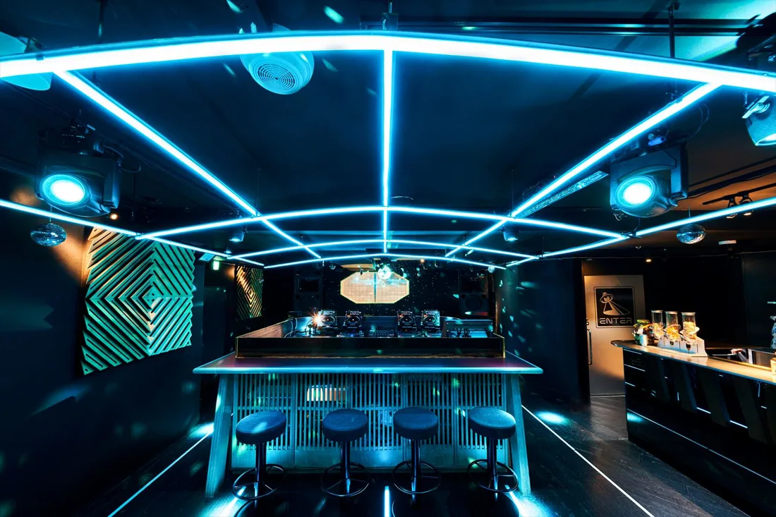 Enter Shibuya bar counter and DJ booth under blue neon ceiling