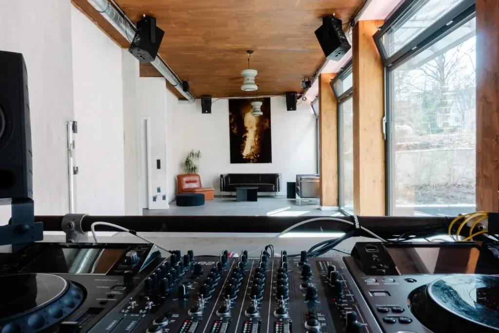 Giri bright timber-ceilinged room with DJ decks, speakers and big windows