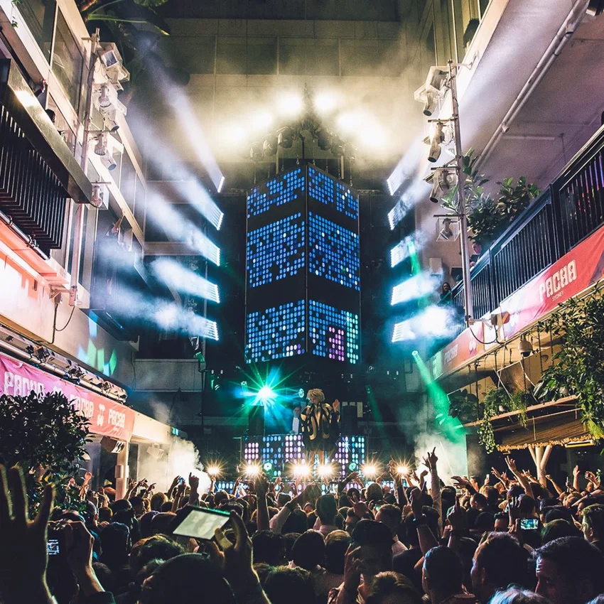 Crowd and stage lighting filling ivy courtyard for Pacha Sydney in 2016