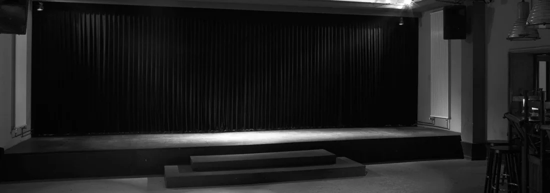 Kantine am Berghain black-and-white view of the empty stage and curtain