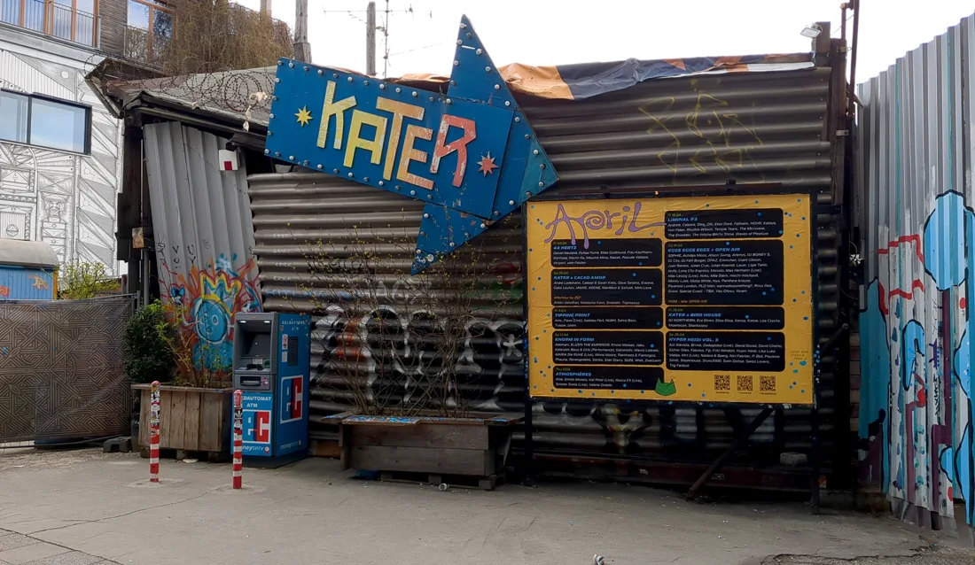 Kater Blau entrance with blue KATER arrow sign and corrugated walls