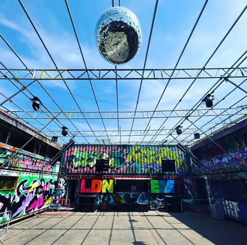 LDN East open-air courtyard with graffiti containers, LDN EAST stage and disco ball