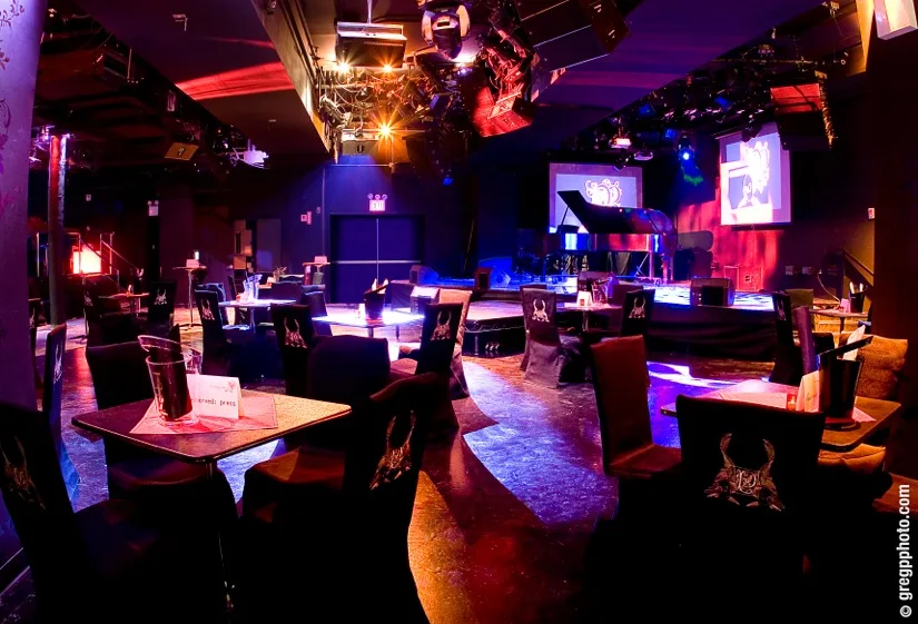 Le Poisson Rouge main room with tables facing the stage and screens