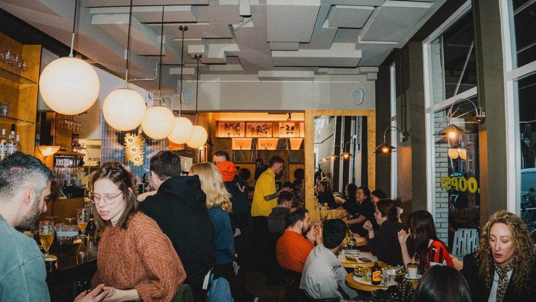 Loop51 busy bar room with globe pendant lamps and shopfront windows