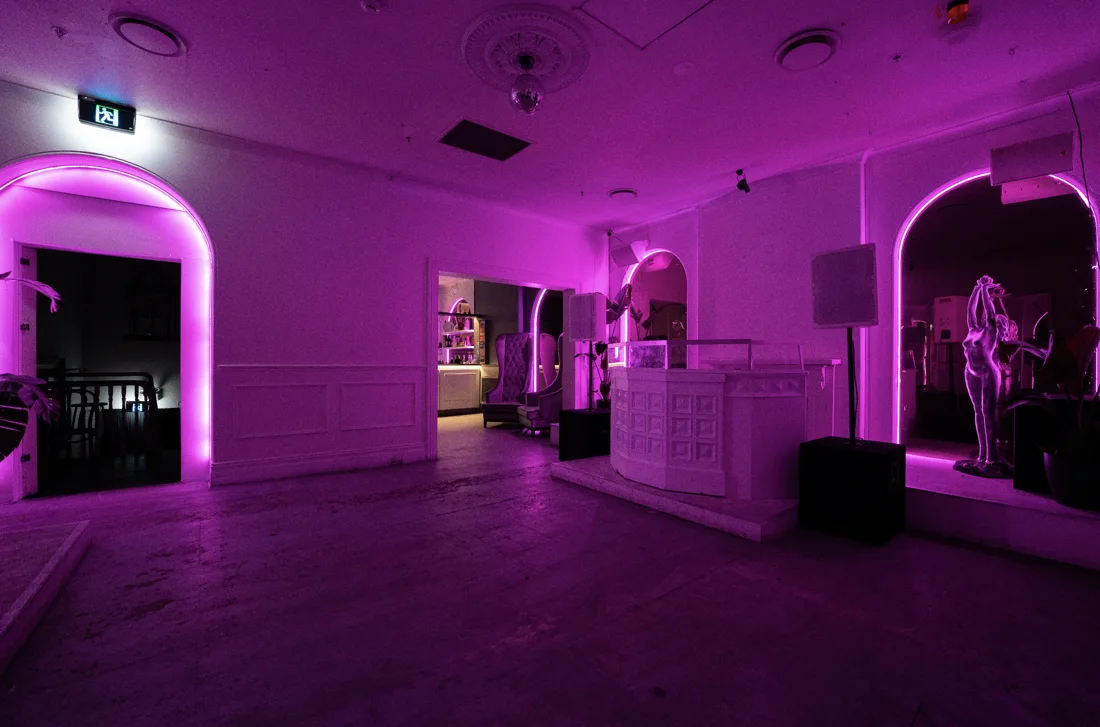 Mansions Potts Point pink-lit room with arched alcoves and DJ booth