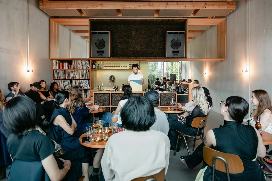migas, a listening bar seated audience before speakers and record shelves