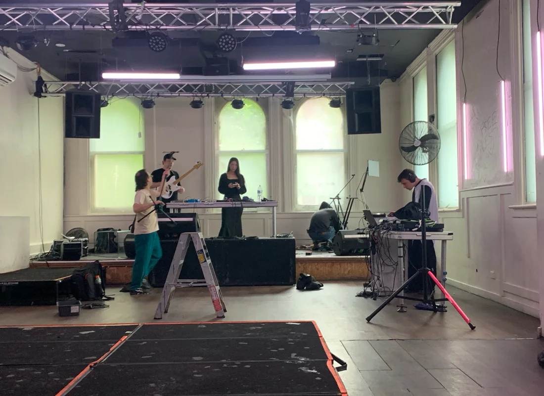 Miscellania upstairs room with arched windows, rig and musicians setting up