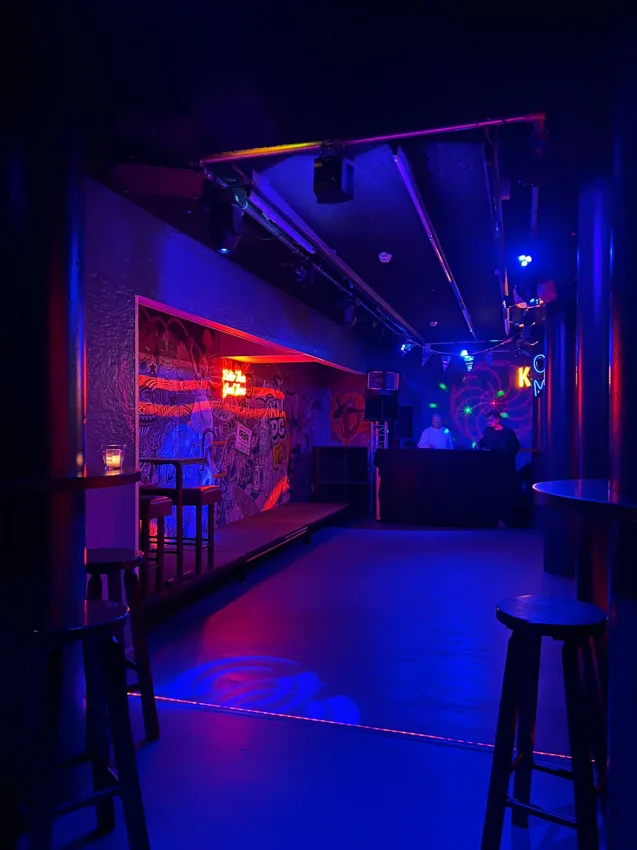 Onder Hans small blue-lit club room with dancefloor and DJ booth