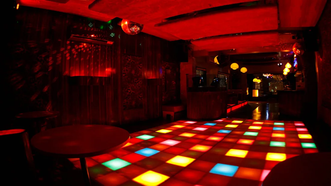 OneSixOne empty dancefloor with illuminated tiles, disco ball and red bar