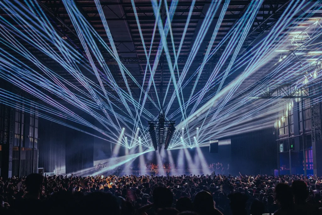 A crowd and overhead laser lighting inside PICA in Port Melbourne