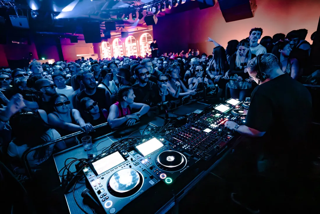 A DJ and packed dancefloor in Plaza Hotel Sydney's Level One room