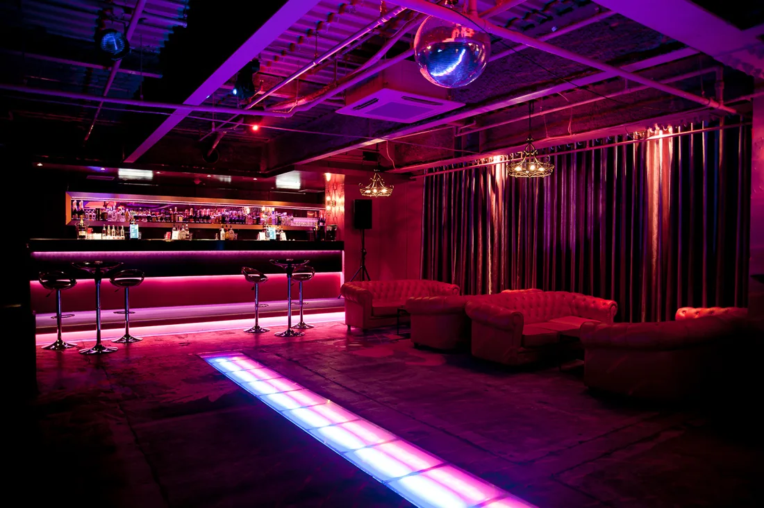 R Lounge 6F bar, sofas and lit dancefloor under a mirror ball