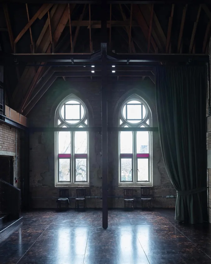 Raleigh Chapel empty hall with timber roof trusses and arched windows