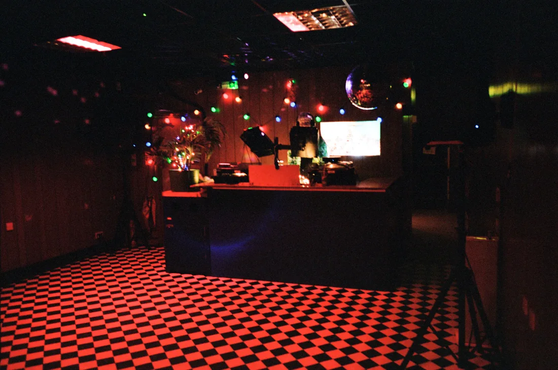 Ridley Road Market Bar empty checkerboard dancefloor with DJ booth and mirrorball