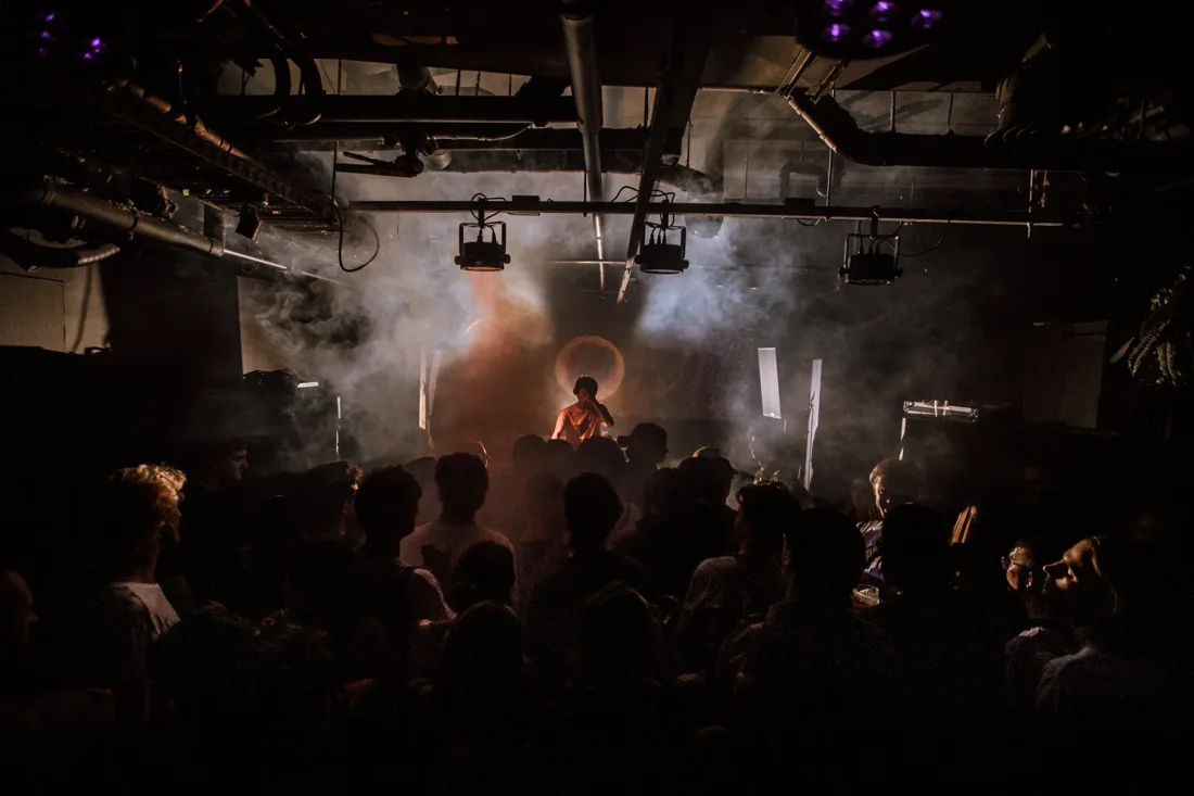 Sub Club Melbourne low concrete basement room, DJ in smoke before crowd