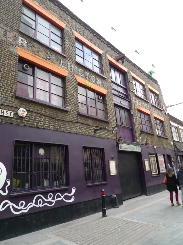 The Lighthouse Bar & Club brick frontage on Rivington Street, purple ground floor