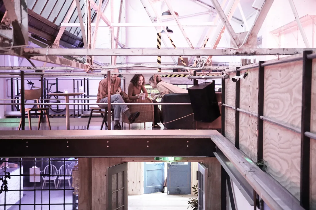 Unit 58 daylit warehouse with white roof trusses and timber mezzanine