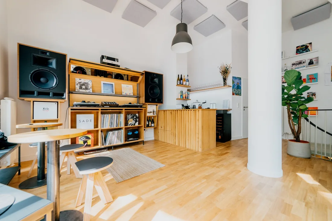 Unkompress bright listening bar with horn speakers, turntables and timber bar