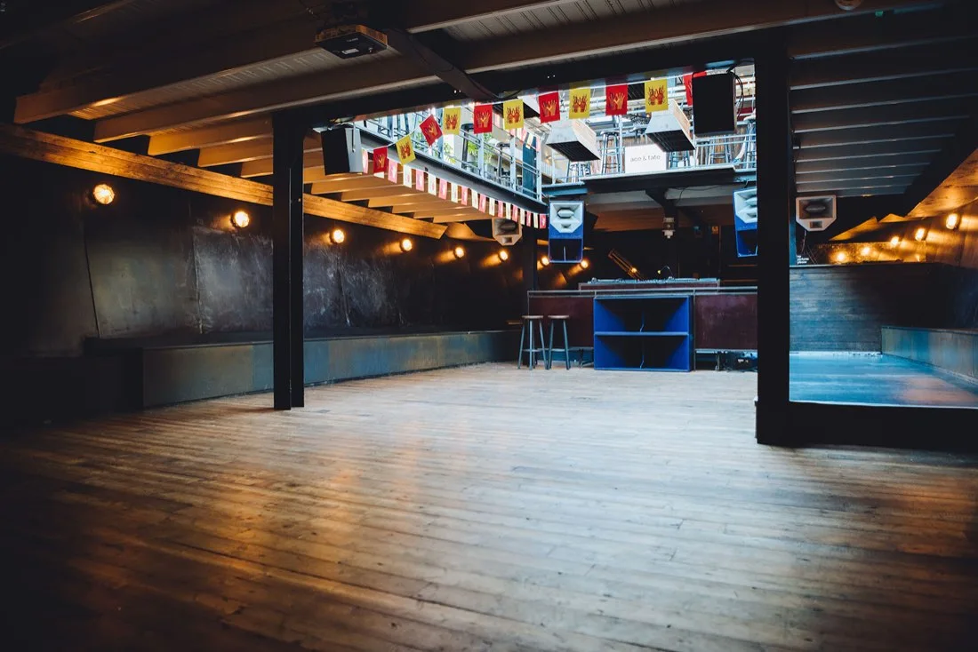 Veronica Schip below-deck wooden dancefloor with DJ booth and bunting