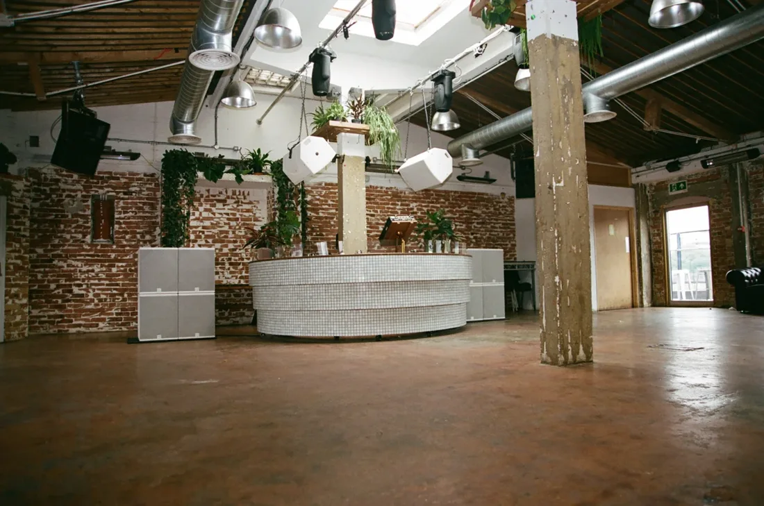 Vittoria Wharf Studio room with tiled round DJ booth and brick walls