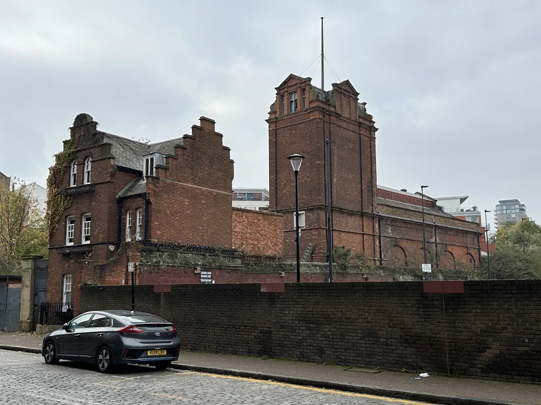 Wapping Hydraulic Power Station red-brick tower and stepped gables from the street