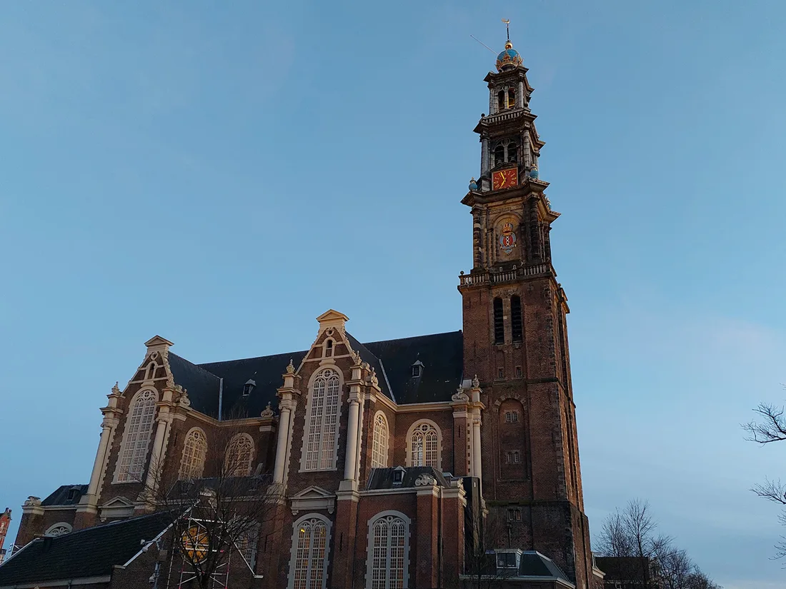 Westerkerk brick church and tall tower against a blue sky
